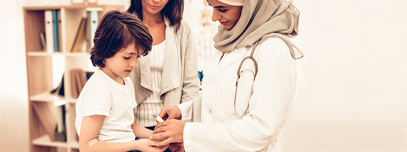 Doctor pricking child's finger