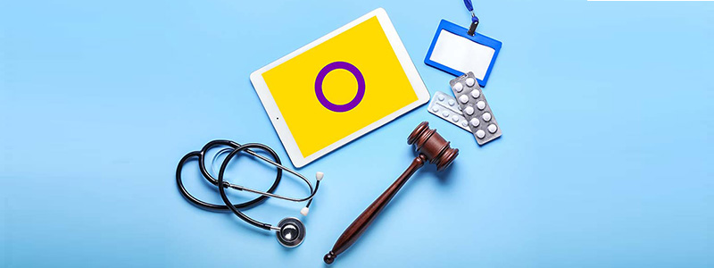 ipad with intersex flag, stethoscope, gavel and medication