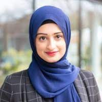A woman, Rahma Ahmed, wears a blue headscarf.